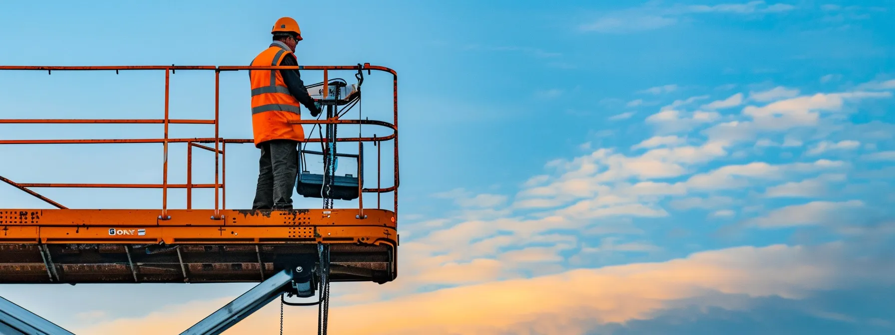 a construction worker safely operating a man lift at a high elevation, showcasing efficiency and safety in action.